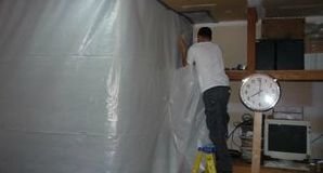 Technician Installing Vapor Barrier For Mold Cleanup