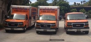 Water and Mold Damage Restoration Van And Trucks At Job Location