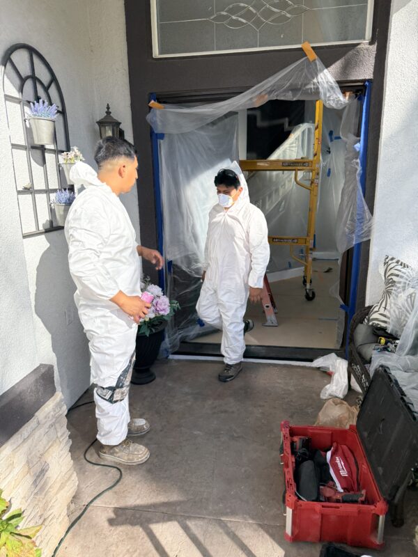 Mold remediation crew wearing protective equipment during affected material removal