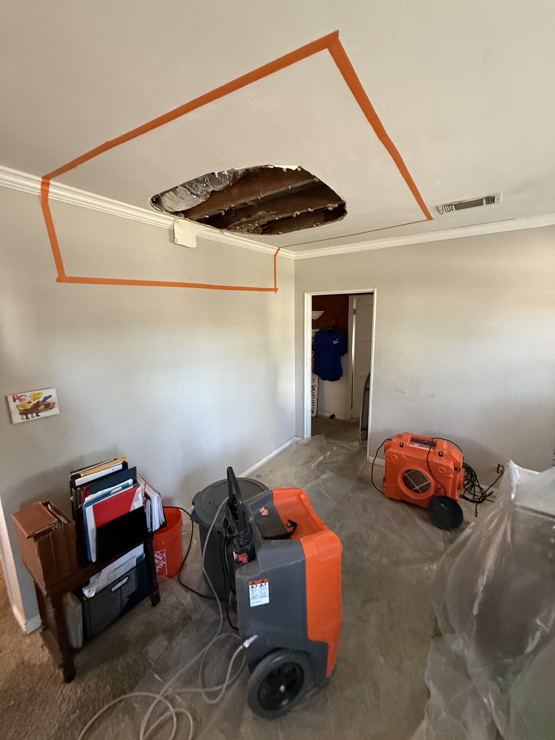 Air movers drying a water-damaged home